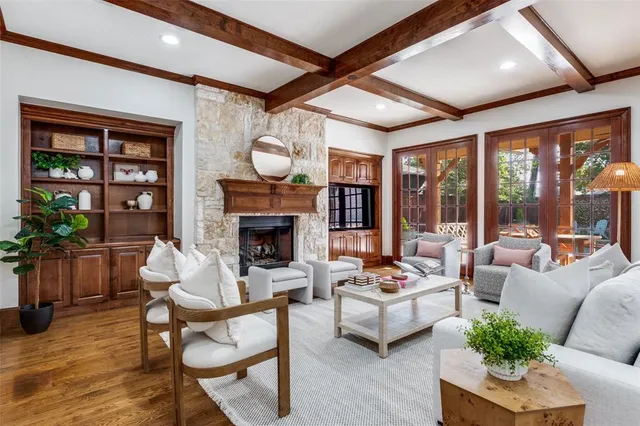 a living room with furniture fireplace and a large window