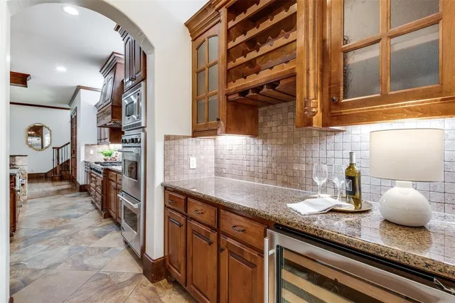 a kitchen with stainless steel appliances granite countertop a sink and cabinets