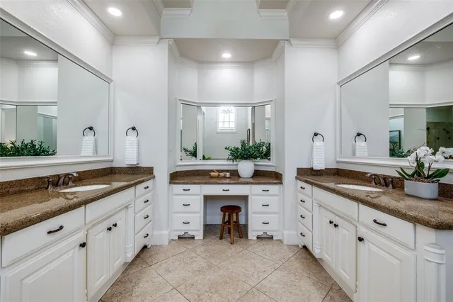 a large white kitchen with a large island