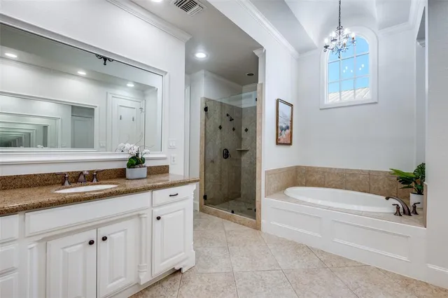 a bathroom with a granite countertop tub a double vanity sink and mirror