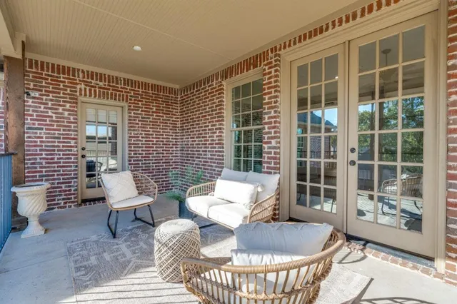 a balcony with furniture and glass door