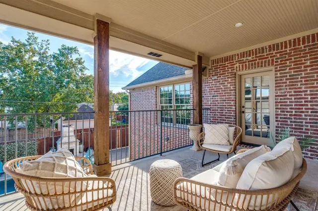 a living room with patio furniture and a potted plant