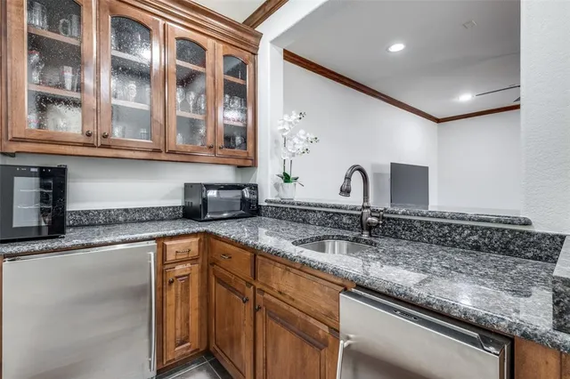 a kitchen with stainless steel appliances granite countertop a sink and cabinets