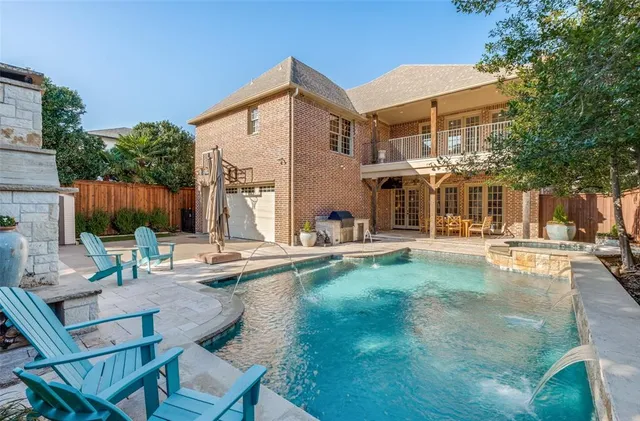 a view of a house with swimming pool and sitting area