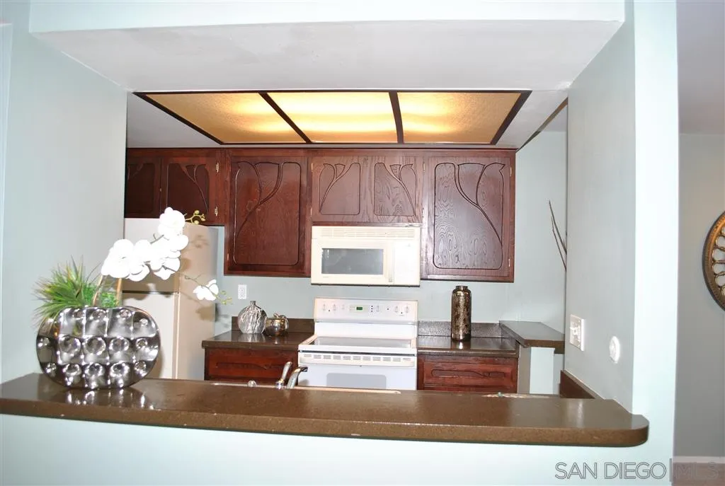 5999 Rancho Mission Road San Diego, CA 92108 - Photo 7 of 25 a bathroom with a sink mirror and vanity