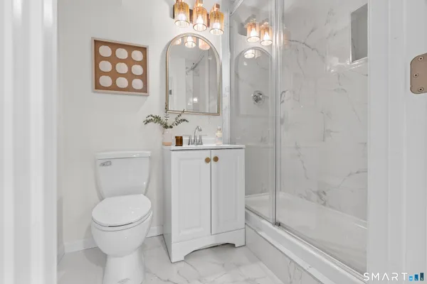 a bathroom with a toilet a sink and bathtub