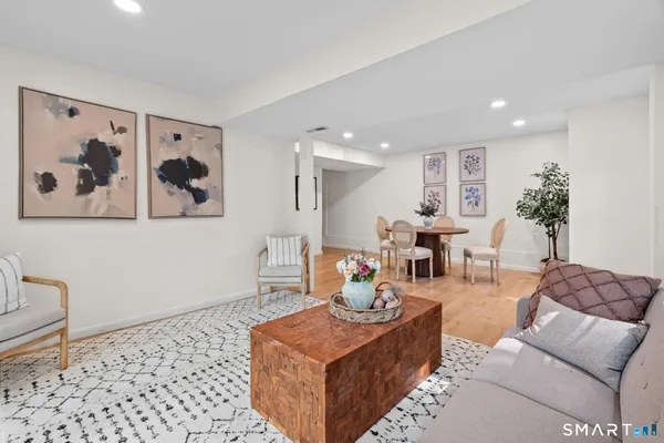 a living room with furniture and wooden floor