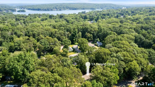 an aerial view of a houses with a yard