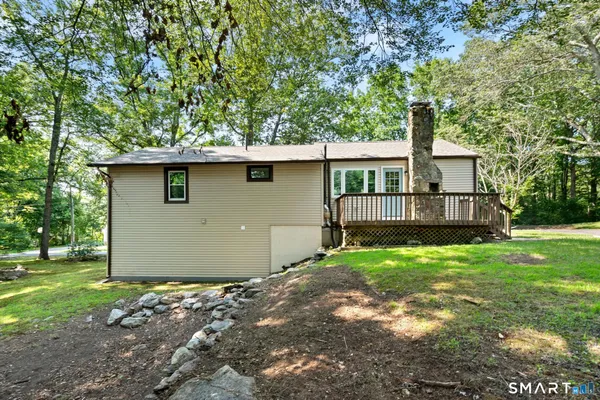 a backyard of a house with a garden and barbeque oven