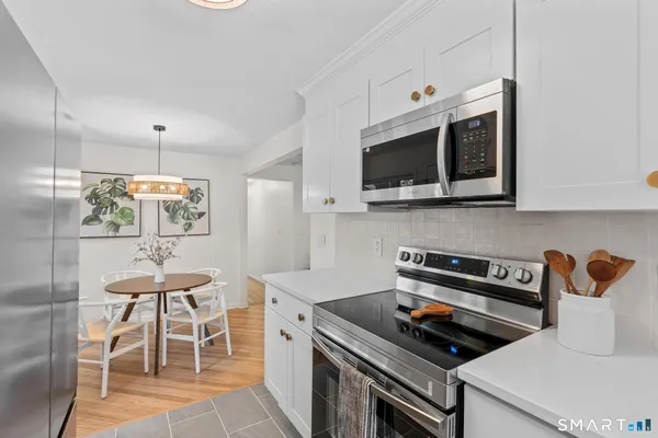 a kitchen with stainless steel appliances a stove a sink and a microwave
