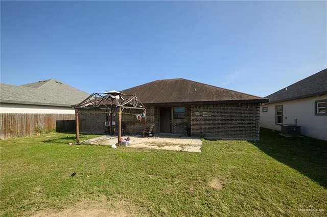 a backyard of a house with yard and outdoor seating
