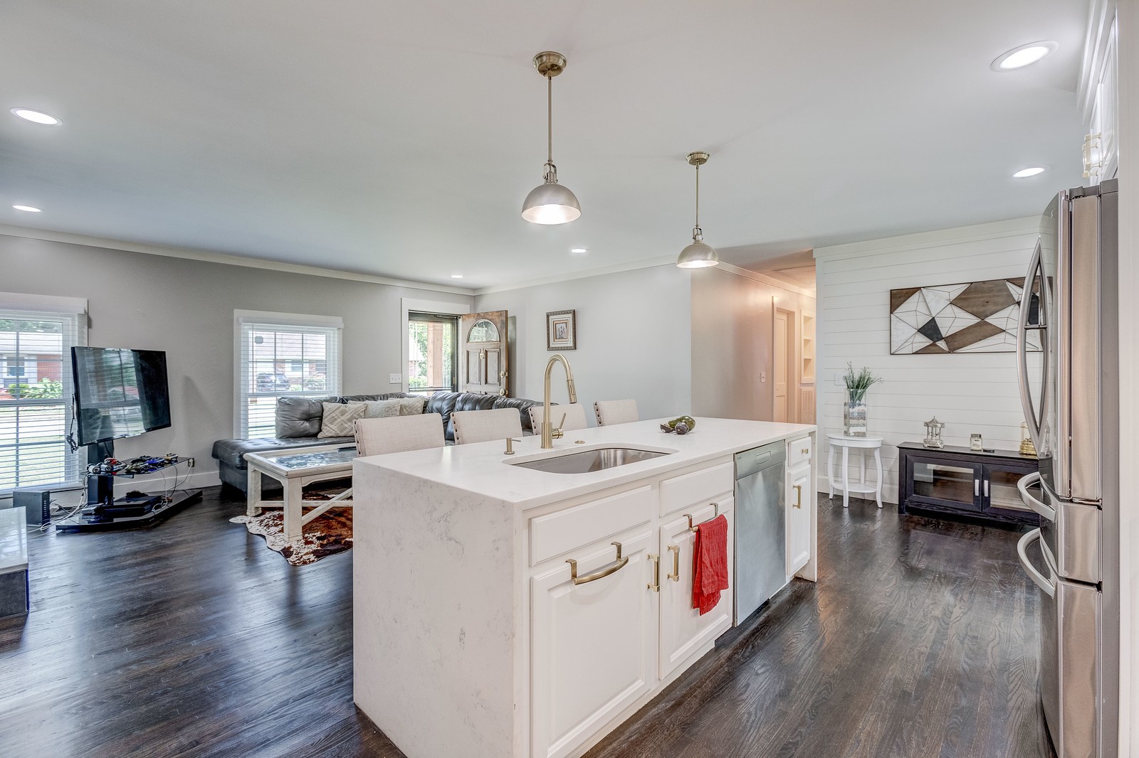 490 Rural Hill Road Nashville, TN 37217 - Photo 15 of 36 a open kitchen with stainless steel appliances granite countertop a stove top oven a refrigerator a dining table and chairs with wooden floor