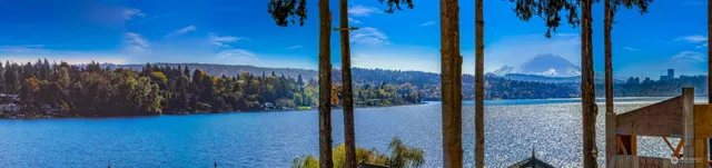a view of a lake with lawn chairs