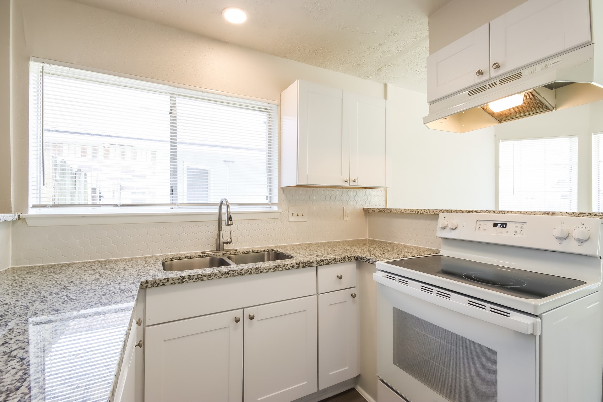 5312 Lynngate Drive Spring, TX 77373 - Photo 6 of 16 a kitchen with a sink cabinets stainless steel appliances and a window