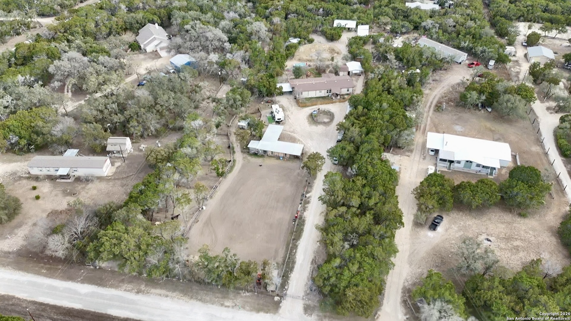 946 Frontier Lane Bandera, TX 78003 - Photo 1 of 49 an aerial view of a house with a yard and trees all around