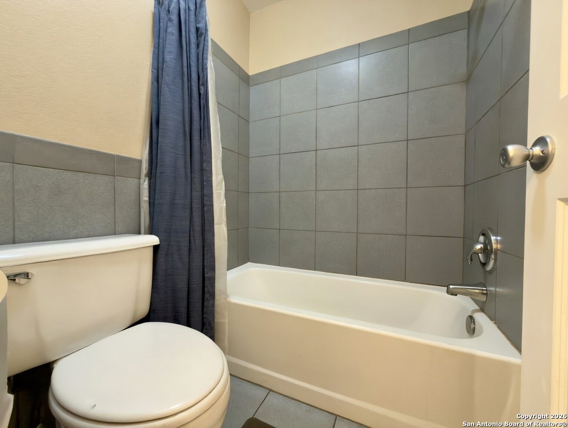 946 Frontier Lane Bandera, TX 78003 - Photo 16 of 48 a white toilet sitting next to a bathtub