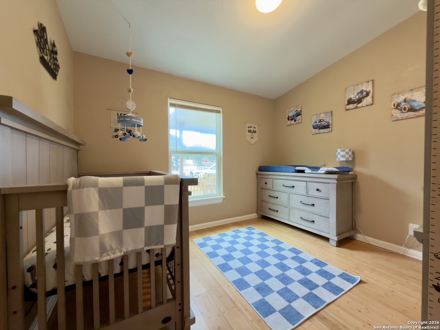 946 Frontier Lane Bandera, TX 78003 - Photo 17 of 48 a bedroom with a bed and wooden floor