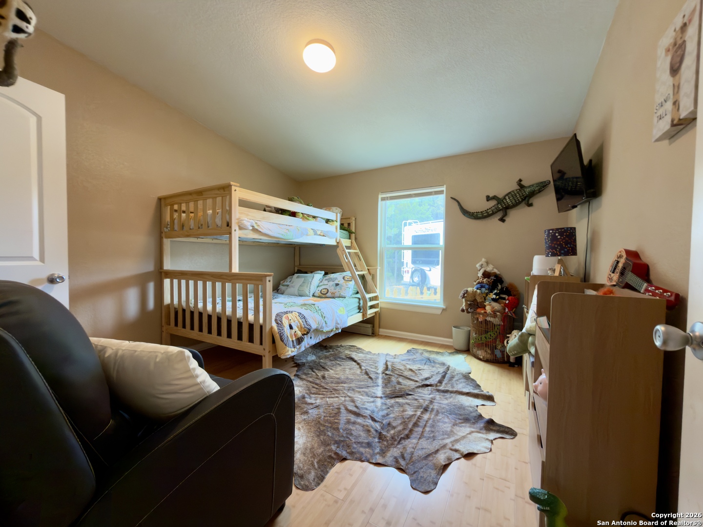 946 Frontier Lane Bandera, TX 78003 - Photo 19 of 48 a bedroom with two beds and a window