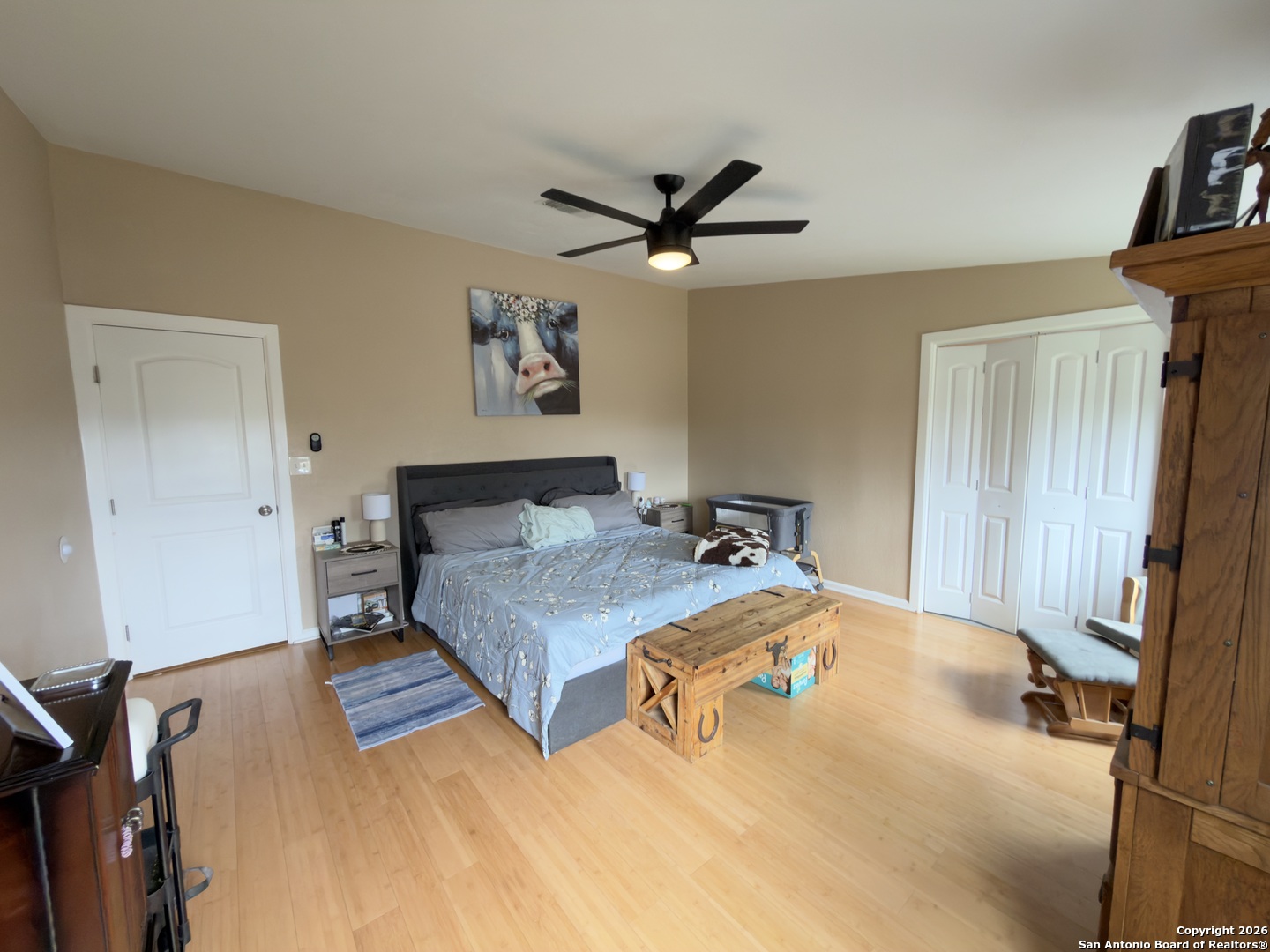 946 Frontier Lane Bandera, TX 78003 - Photo 21 of 49 a bedroom with a bed and a chandelier