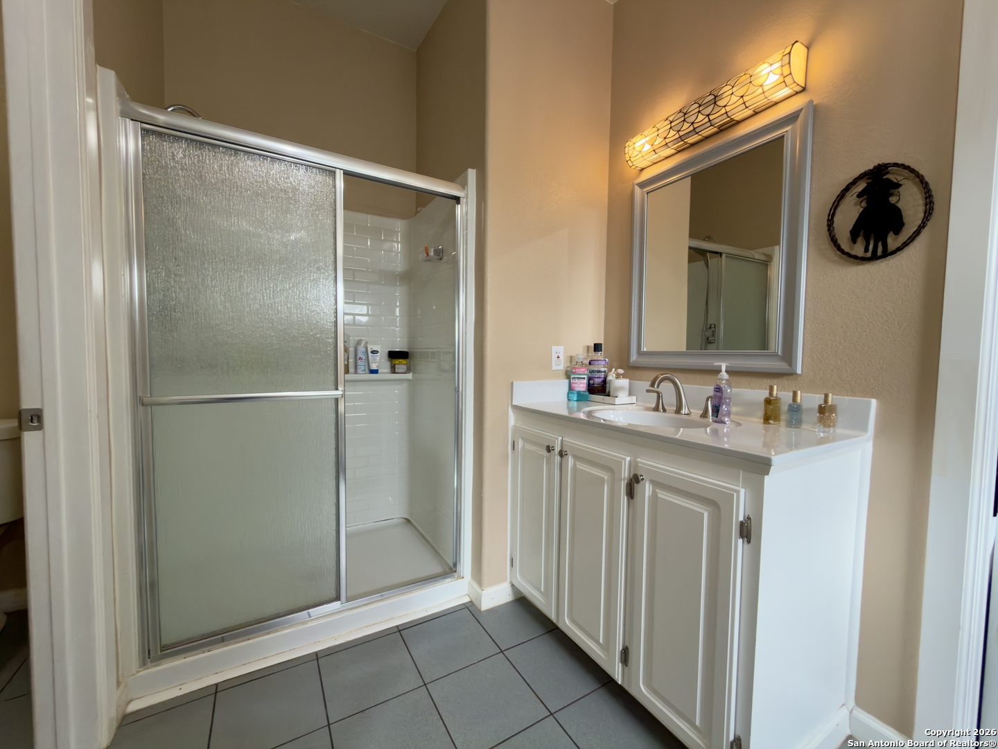 946 Frontier Lane Bandera, TX 78003 - Photo 23 of 49 a bathroom with a shower sink and mirror