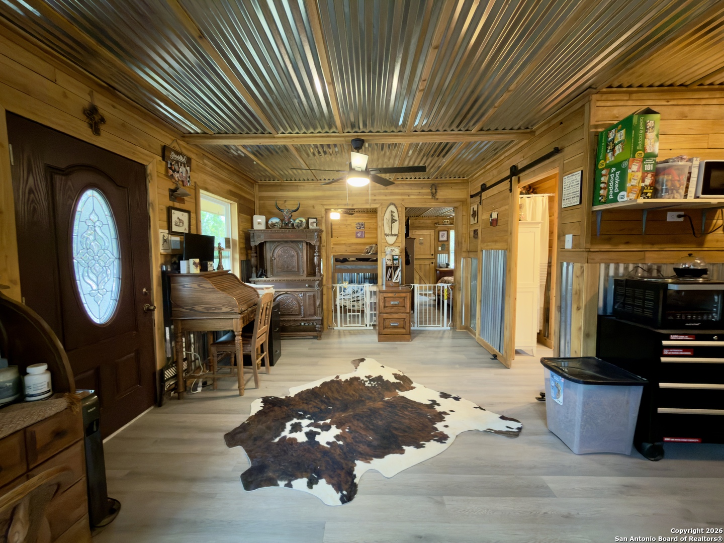 946 Frontier Lane Bandera, TX 78003 - Photo 32 of 49 a living room with lots of furniture and a chandelier