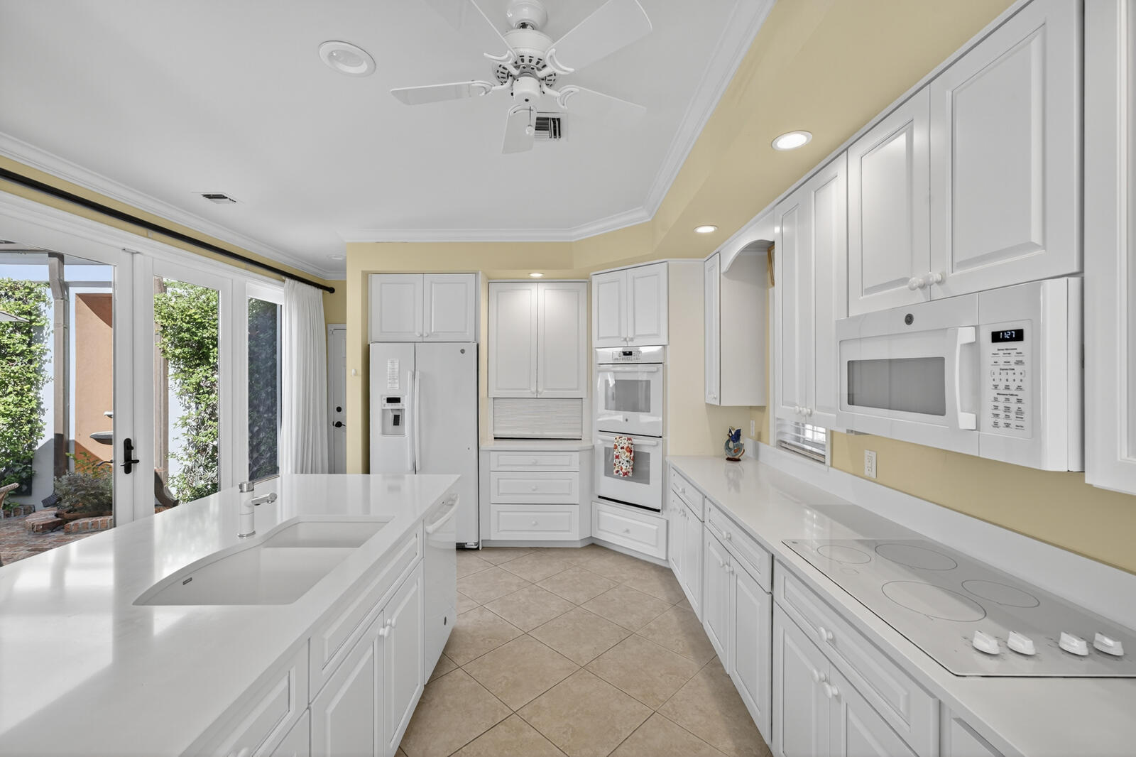 625 Riomar Drive Vero Beach, FL 32963 - Photo 21 of 54 a large white kitchen with a large window and stainless steel appliances