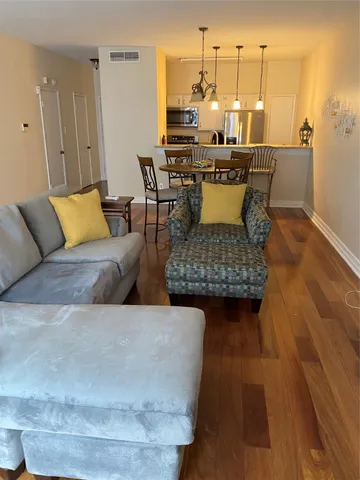 a living room with furniture and a chandelier