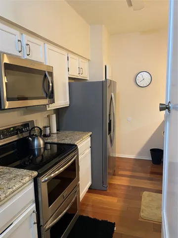a kitchen with a refrigerator stove and microwave