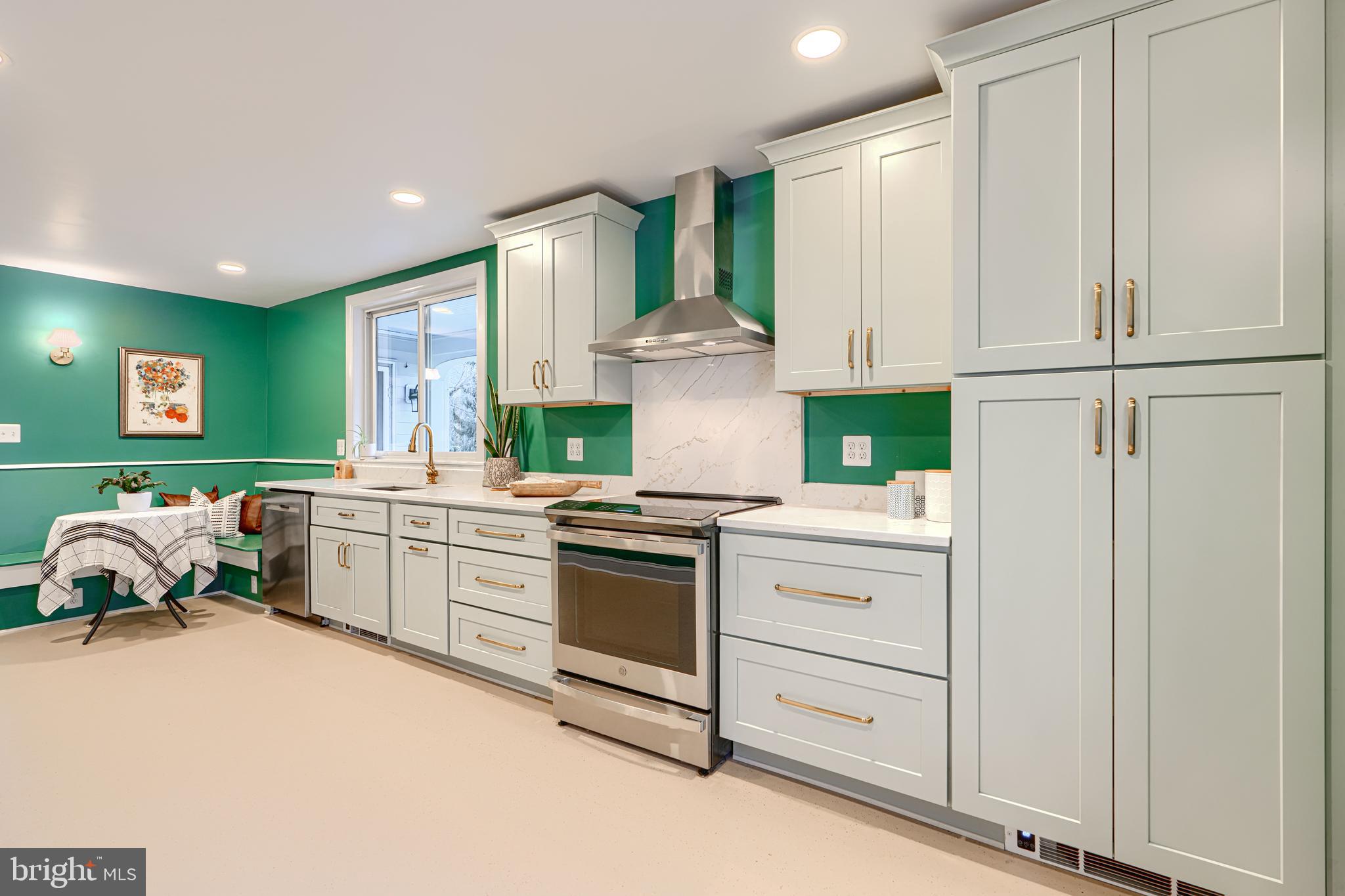5000 Greenleaf Road Baltimore, MD 21210 - Photo 12 of 45 a kitchen with stainless steel appliances granite countertop a stove a refrigerator and a white cabinets with wooden floor