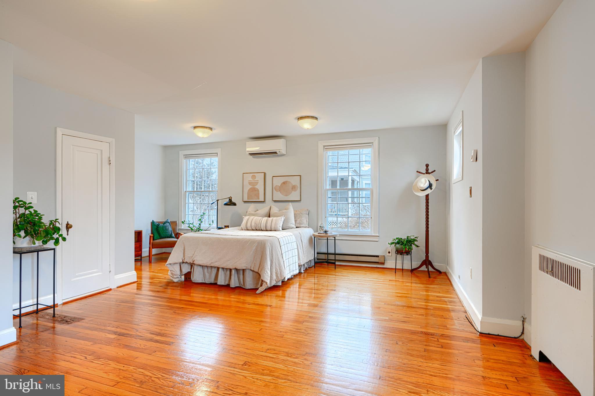 5000 Greenleaf Road Baltimore, MD 21210 - Photo 19 of 45 a spacious bedroom with a bed and a wooden floor