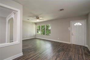 4934 Perry Street Houston, TX 77021 - Photo 9 of 9 a view of an empty room with wooden floor and a window