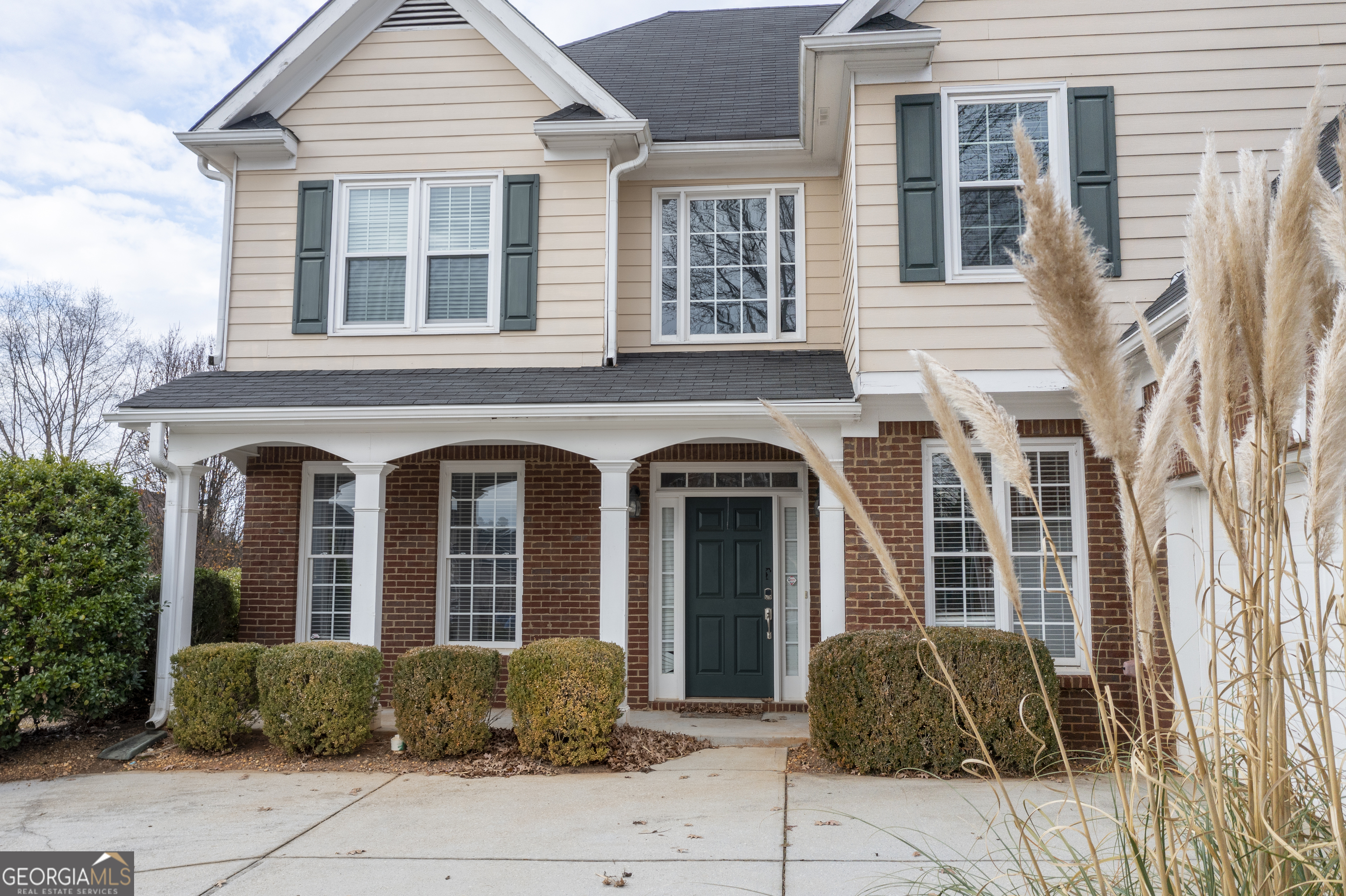 a front view of a house with a garden