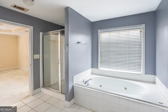 a bathroom with a bathtub and a shower