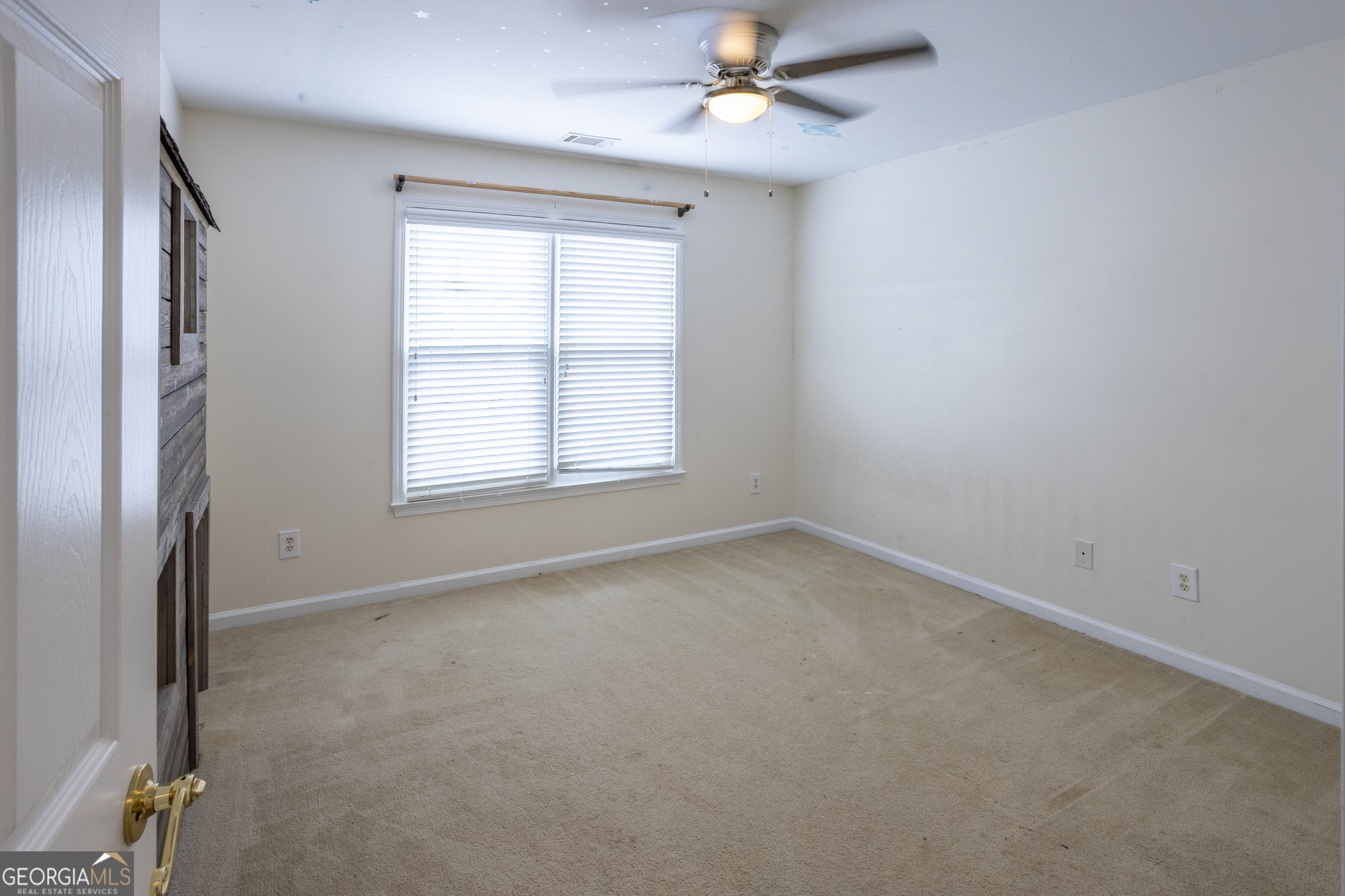 1031 Jordan Road Dacula, GA 30019 - Photo 20 of 35 an empty room with a window and a fan