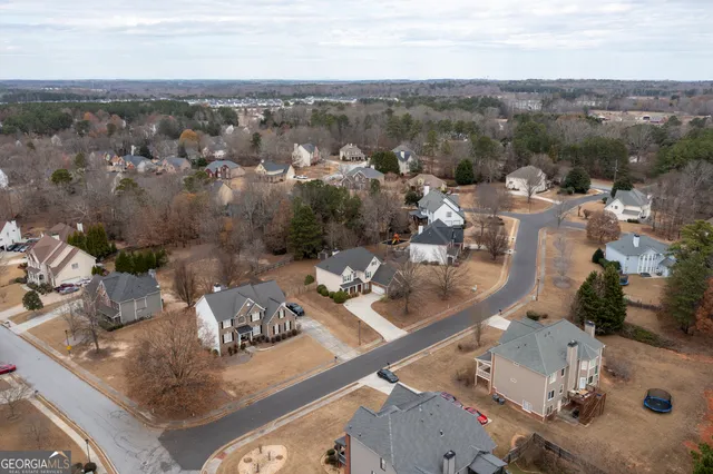 an aerial view of a house with outdoor seating