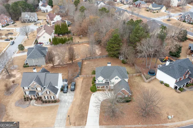 an aerial view of a house with a yard