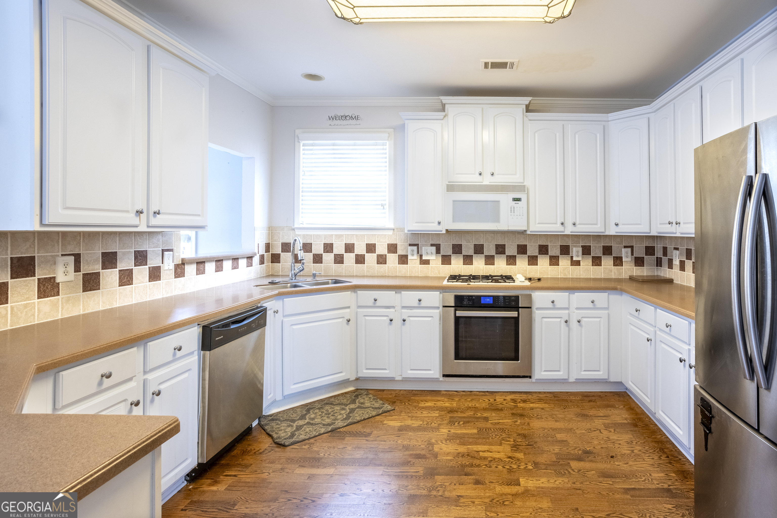 1031 Jordan Road Dacula, GA 30019 - Photo 4 of 35 a kitchen with stainless steel appliances granite countertop a stove a sink dishwasher and a refrigerator