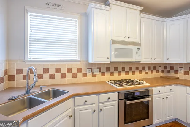 a kitchen with granite countertop a sink and a stove