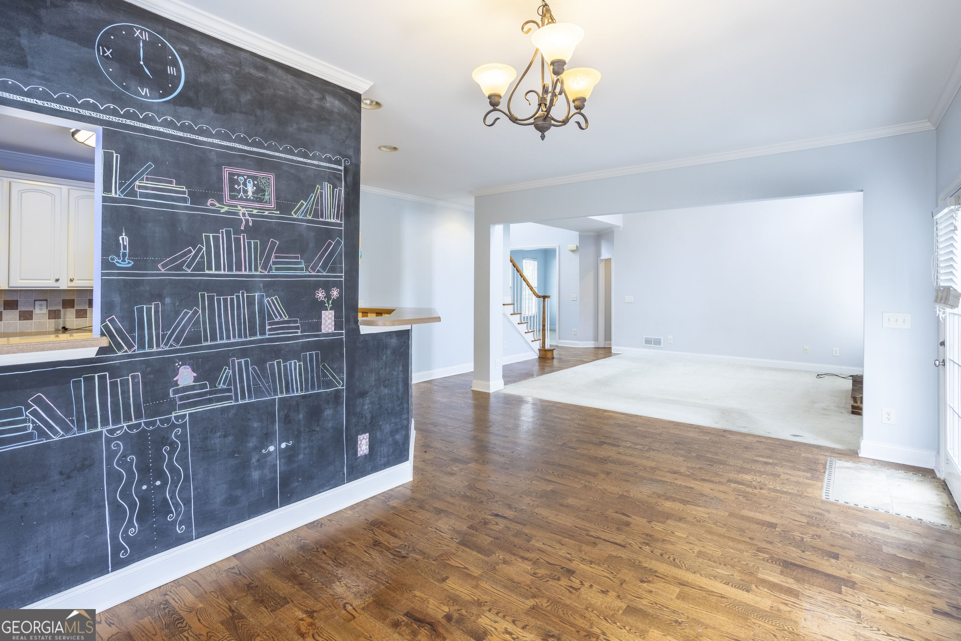 1031 Jordan Road Dacula, GA 30019 - Photo 8 of 35 a view of a livingroom with wooden floor and a chandelier