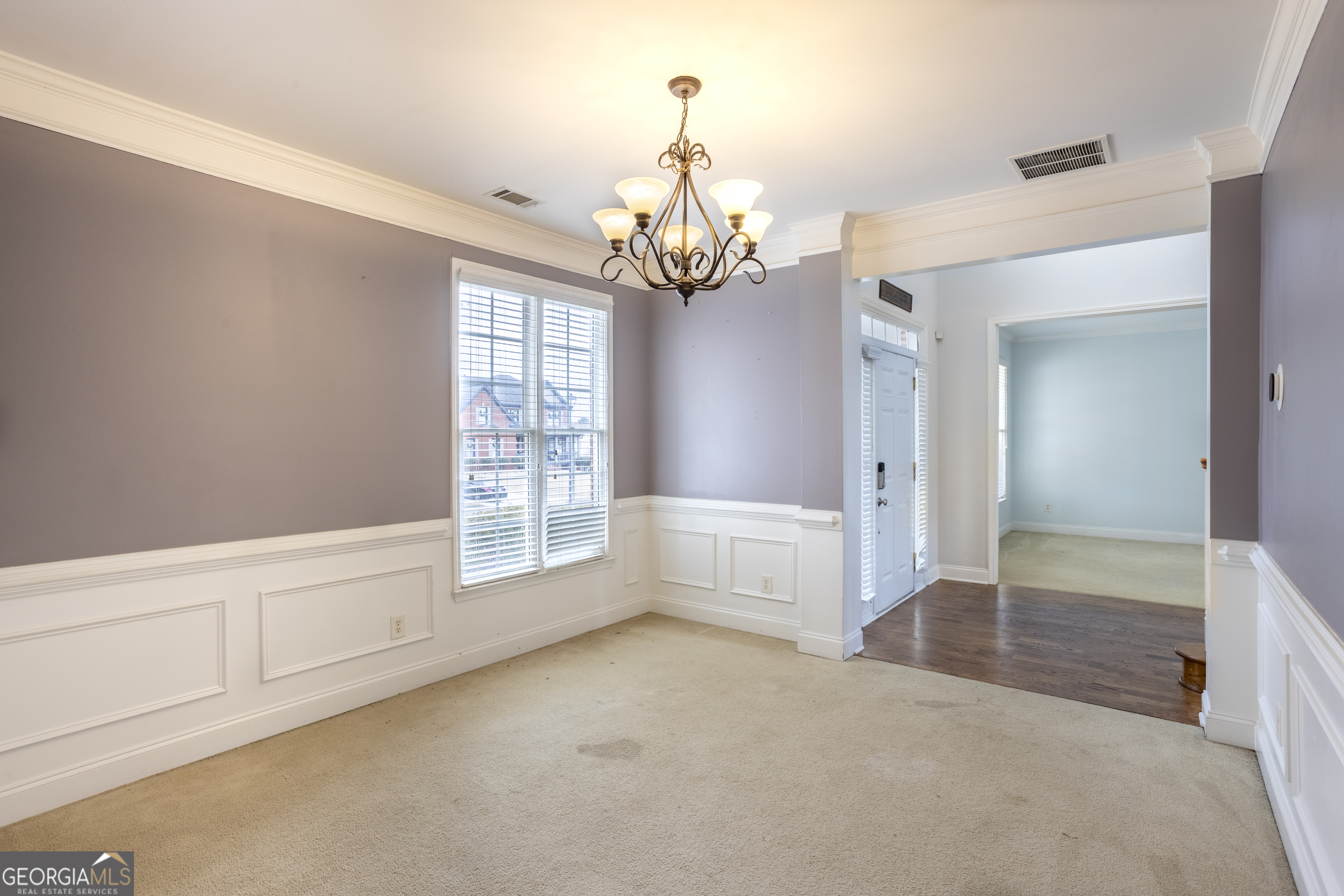 1031 Jordan Road Dacula, GA 30019 - Photo 9 of 35 a view of an empty room with chandelier and kitchen view
