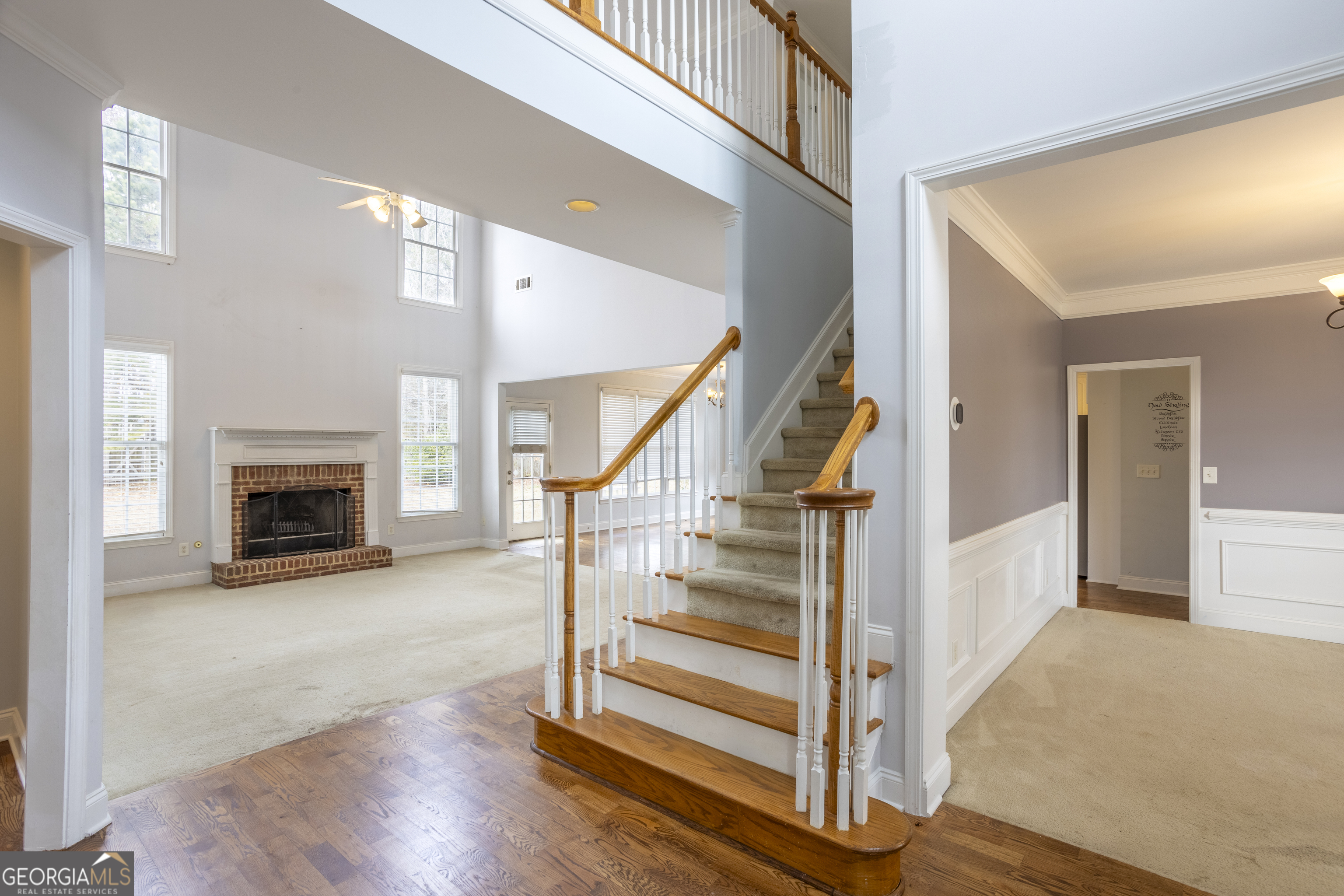 1031 Jordan Road Dacula, GA 30019 - Photo 10 of 35 a view of a hallway with wooden floor fireplace and staircase