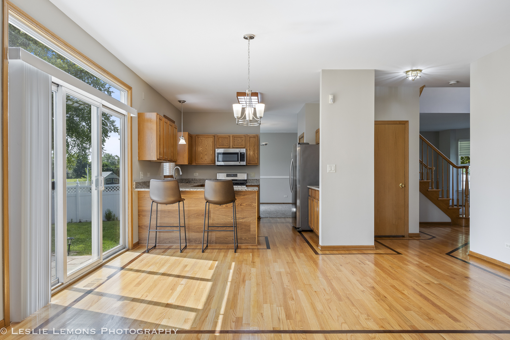 13141 Cinnamon Circle Plainfield, IL 60585 - Photo 11 of 35 a view of a kitchen with furniture and a floor to ceiling window
