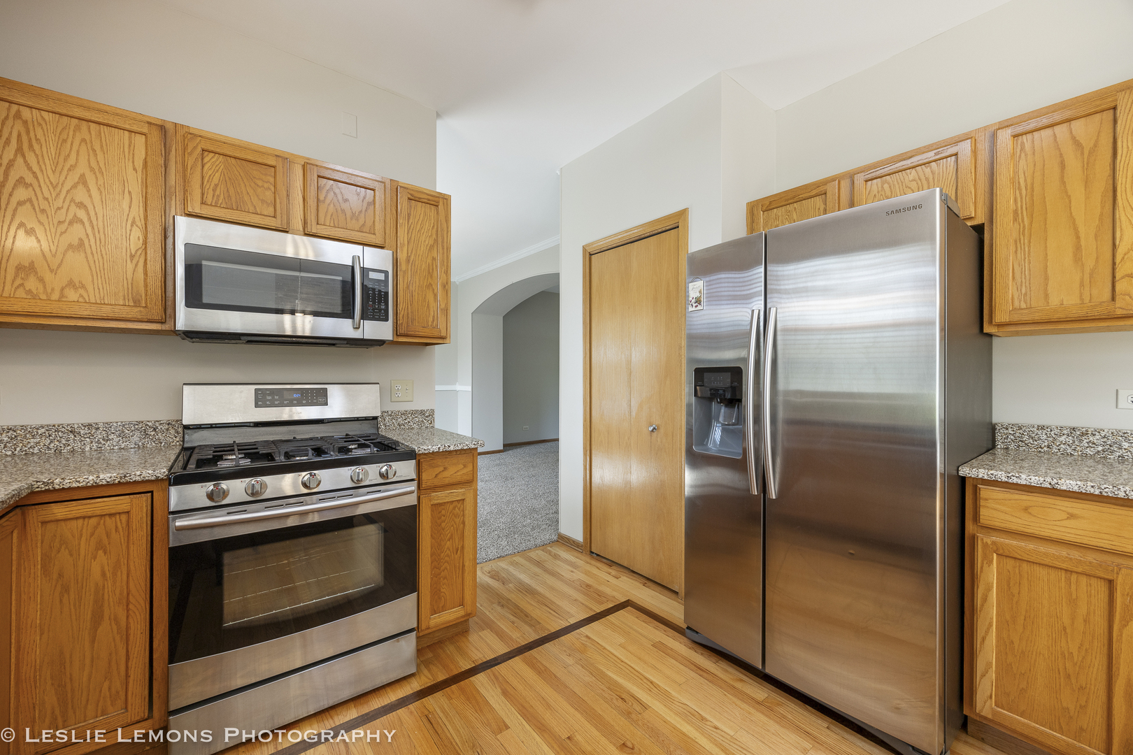 13141 Cinnamon Circle Plainfield, IL 60585 - Photo 14 of 35 a kitchen with granite countertop wooden cabinets stainless steel appliances and a window
