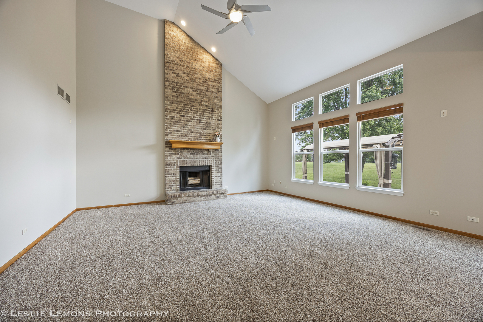 13141 Cinnamon Circle Plainfield, IL 60585 - Photo 17 of 35 a view of an empty room with a fireplace and a window