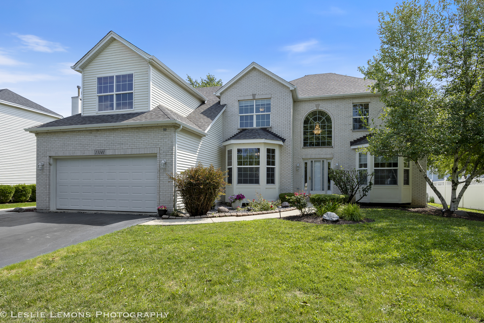 13141 Cinnamon Circle Plainfield, IL 60585 - Photo 2 of 35 a front view of a house with a yard and trees