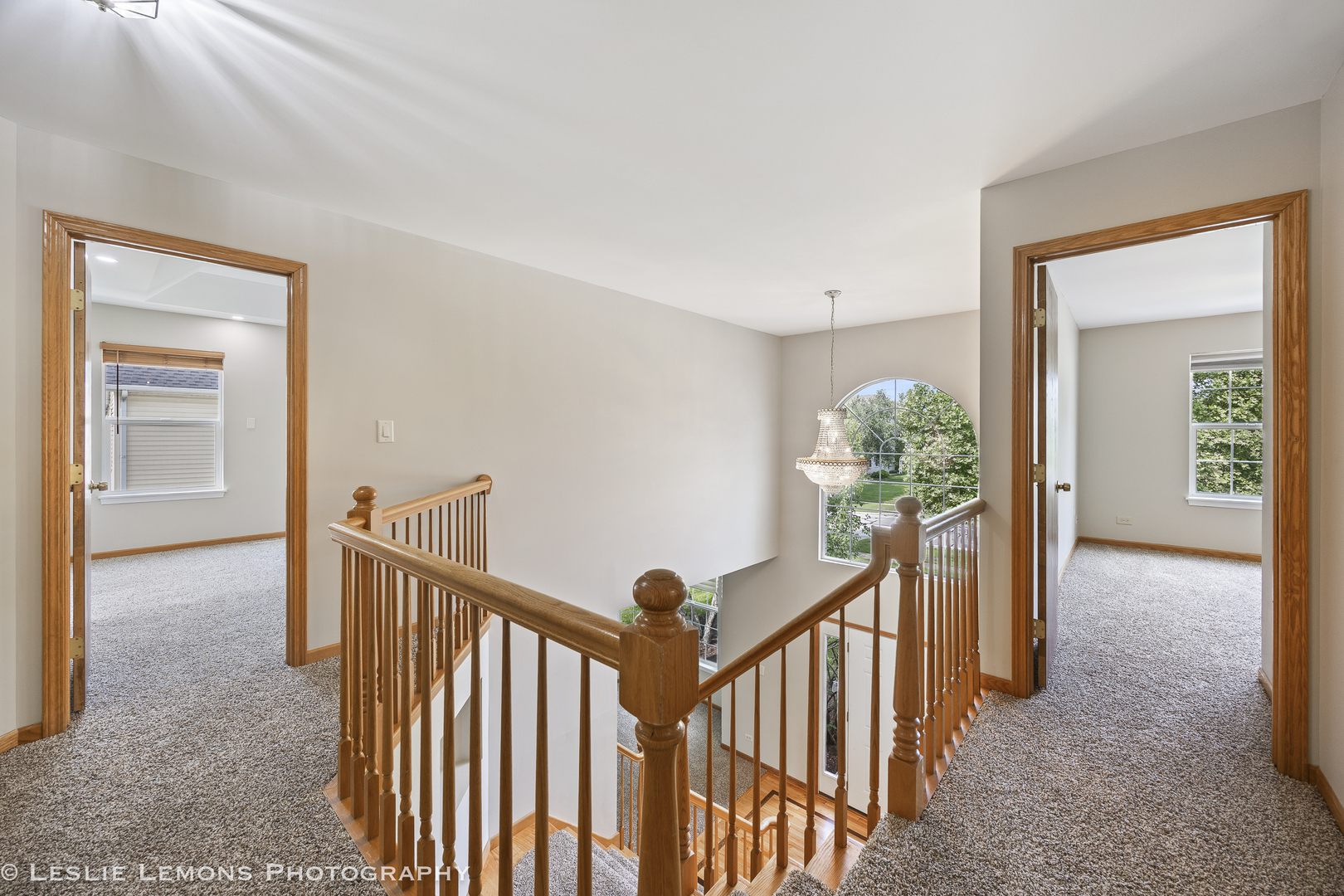 13141 Cinnamon Circle Plainfield, IL 60585 - Photo 21 of 35 a view of a hallway to a livingroom with wooden floor and stairs