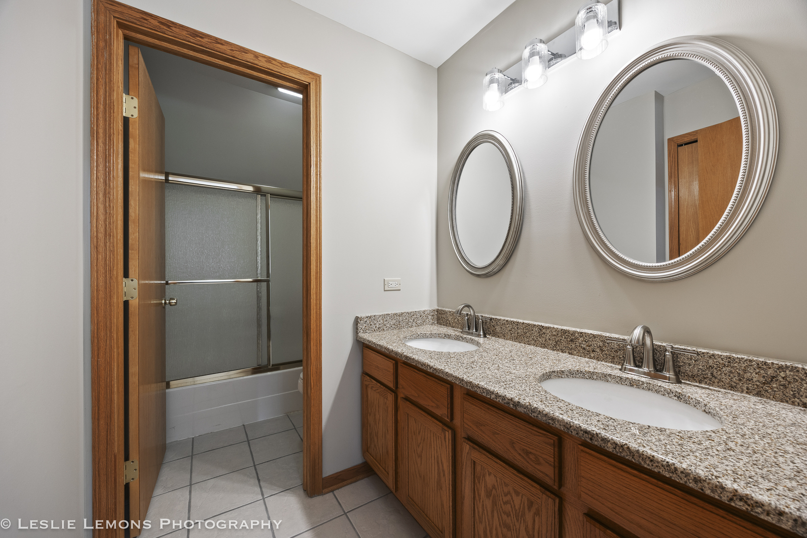 13141 Cinnamon Circle Plainfield, IL 60585 - Photo 26 of 35 a bathroom with a granite countertop double vanity sink and a mirror