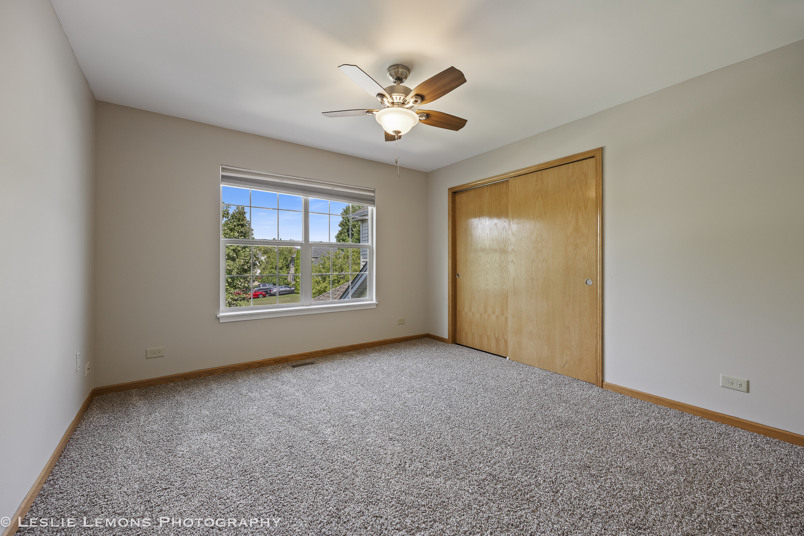 13141 Cinnamon Circle Plainfield, IL 60585 - Photo 28 of 35 a view of a livingroom with a ceiling fan and window