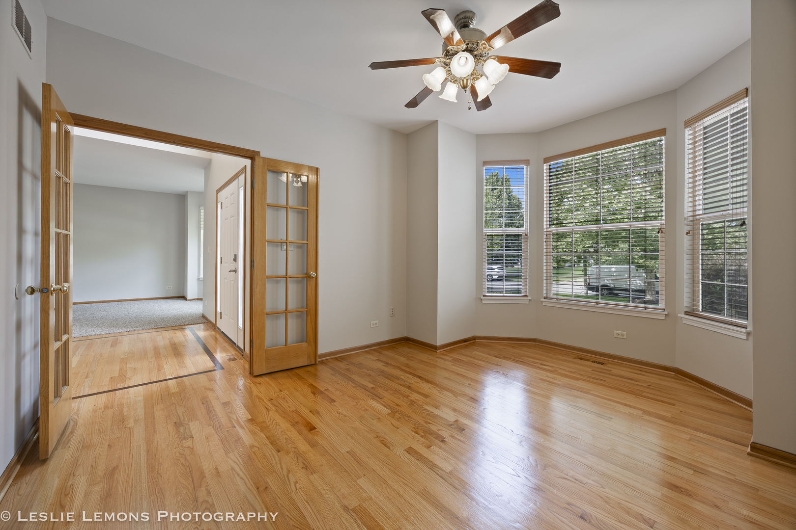 13141 Cinnamon Circle Plainfield, IL 60585 - Photo 7 of 35 a view of an empty room with a window and wooden floor