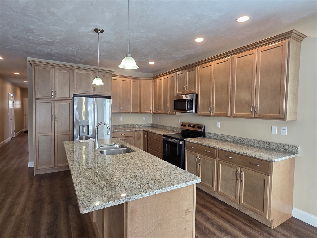 12 Fidelity Drive, Unit 6 Rutland, MA 01543 - Photo 2 of 9 a kitchen with stainless steel appliances granite countertop a sink refrigerator and cabinets